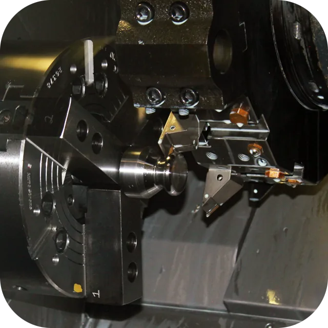 CNC lathe with live tooling turning a steel part