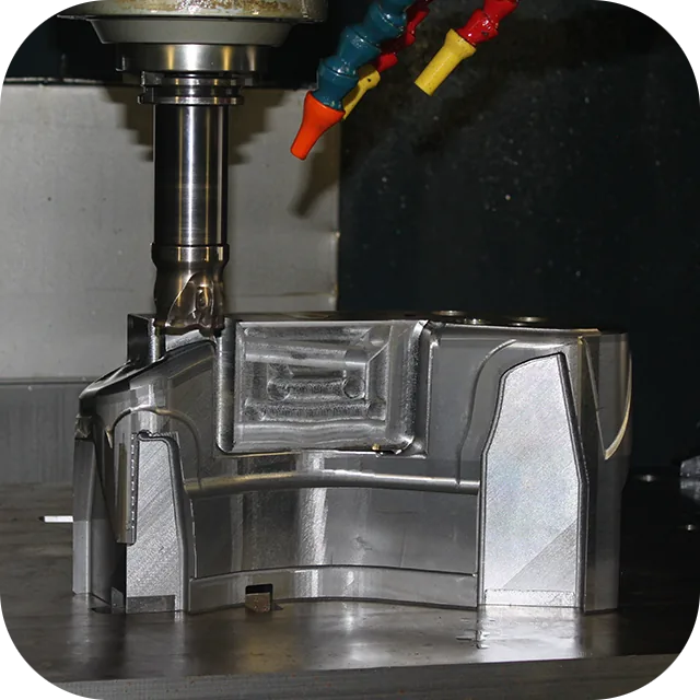 CNC vertical machining center milling a steel tooling component