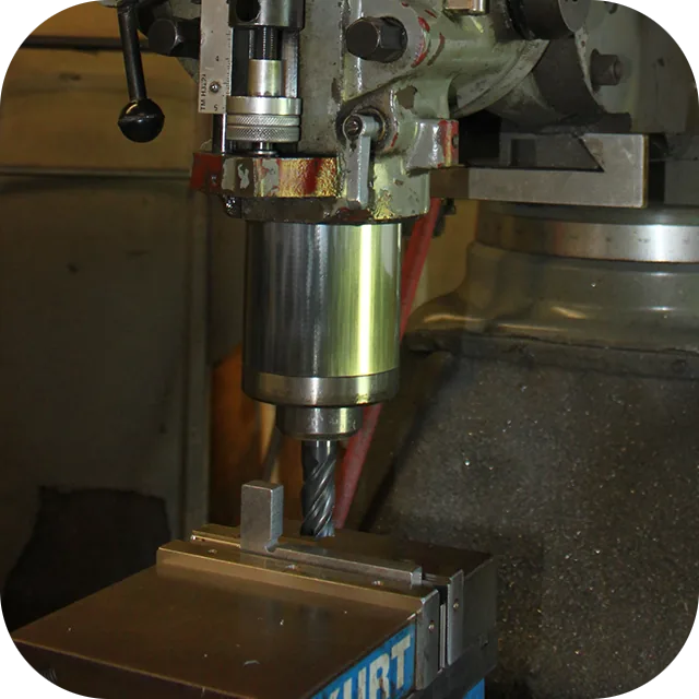 Manual Bridgeport style vertical mill machining a tooling detail
