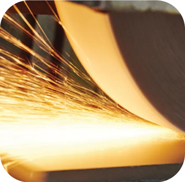 Surface grinding a tool steel block, sparks from the grinding wheel